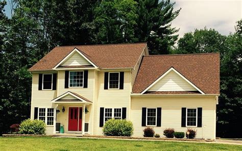 yellow house with brown metal roof|yellow house with charcoal roof.